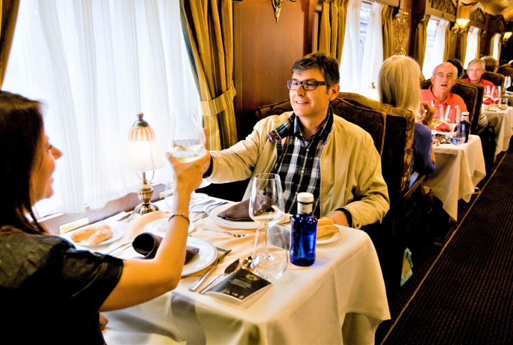 Costa Verde train diners toasting drinks, elegant dining in Spain